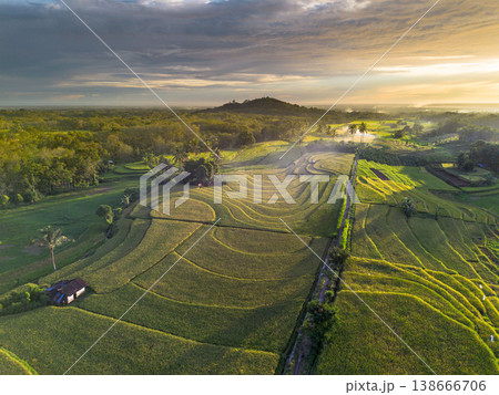 Beautiful morning view in Indonesia, panoramic landscape of rice fields with mountain ranges and clear sky Beautiful morning view in Indonesia, panoramic landscape of rice fields with mountain ranges and clear sky 138666706