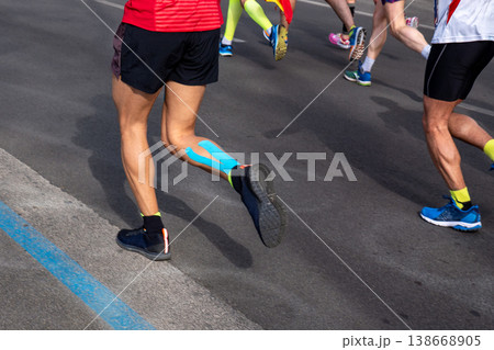 Male runner legs, on calf muscle kinesiotaping Male runner legs, on calf muscle kinesiotaping 138668905