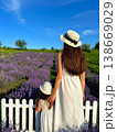 Mom and daughter standing looking at lavender field. 138669029
