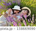 Mom and daughter in white dresses are lying in a lavender field. Provence. 138669090