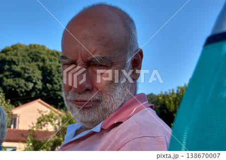Close-up of a retired man with a white beard making playful facial expressions Close-up of a retired man with a white beard making playful facial expressions 138670007