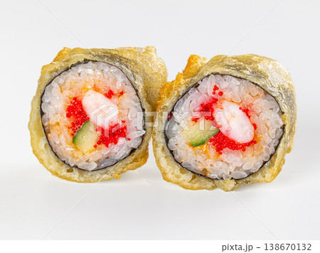 Two fried tempura sushi rolls with shrimp, tobiko, and cucumber isolated on a white background. 138670132