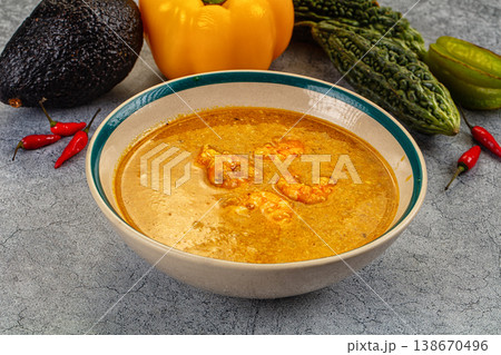 Authentic shrimp curry in a bowl with fresh chili, pepper, and avocado ingredients. Authentic shrimp curry in a bowl with fresh chili, pepper, and avocado ingredients. 138670496