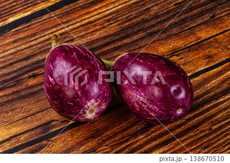 Fresh striped graffiti eggplants on a rustic table Fresh striped graffiti eggplants on a rustic table 138670510