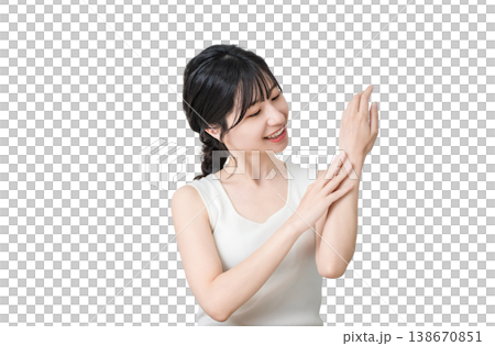 Japanese woman applying hand cream to the back of her hand (hand care, skin care) 138670851