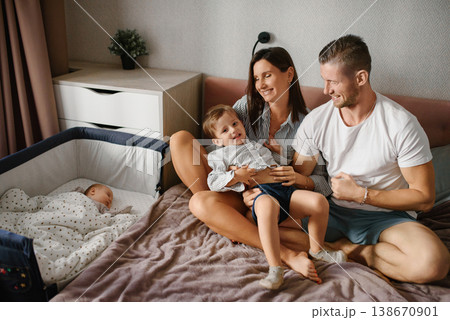 Young Mother And Father Playing With Son At Home Young Mother And Father Playing With Son At Home 138670901