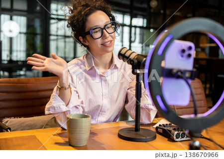 Female host gesturing and talking during live stream 138670966
