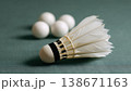 Badminton shuttlecock and table tennis balls showing sports equipment for competitive play, leisure activities, and game preparation on a green surface 138671163