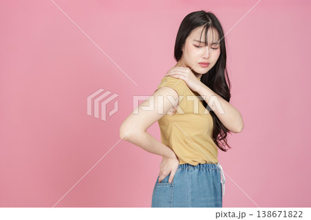 Woman with shoulder and back pain holding her neck Woman with shoulder and back pain holding her neck 138671822