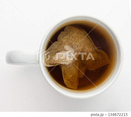 Herbal tea sachet in cup, hot water with chamomile and Hypericum or St. John's wort teabag 138672215