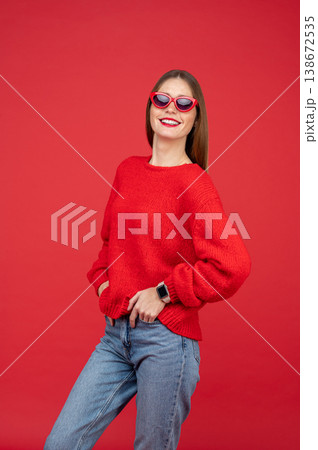 Cheerful woman in sunglasses standing confidently Cheerful woman in sunglasses standing confidently 138672535