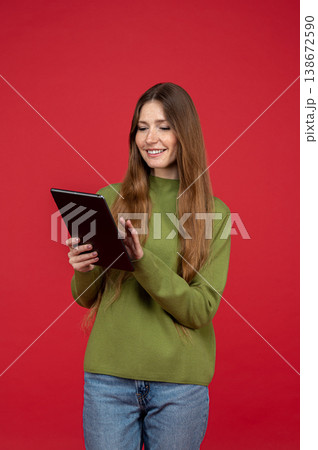 Smiling woman using tablet device and interacting with touch screen 138672590