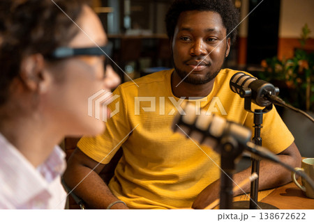 Woman listening to partner during audio content creation Woman listening to partner during audio content creation 138672622