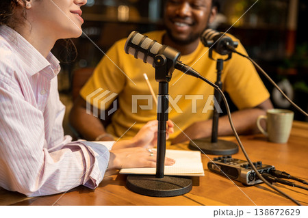Female podcaster explaining idea to colleague in studio Female podcaster explaining idea to colleague in studio 138672629