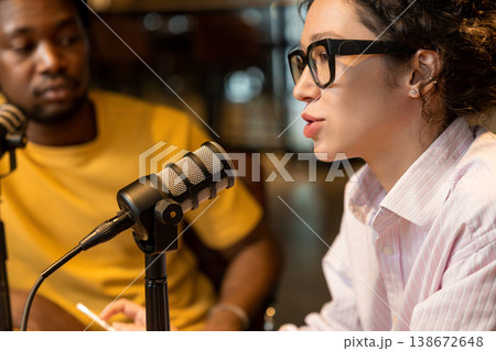 Caucasian woman speaking into microphone during podcast Caucasian woman speaking into microphone during podcast 138672648