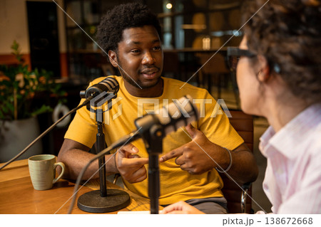 Man pointing and talking to colleague in studio 138672668