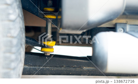 Rear suspension assembly of a Passenger Pickup Vehicle has yellow rubber bushings. After prolonged use these rubber bushings can become warped. Rear suspension assembly of a Passenger Pickup Vehicle has yellow rubber bushings. After prolonged use these rubber bushings can become warped. 138672716