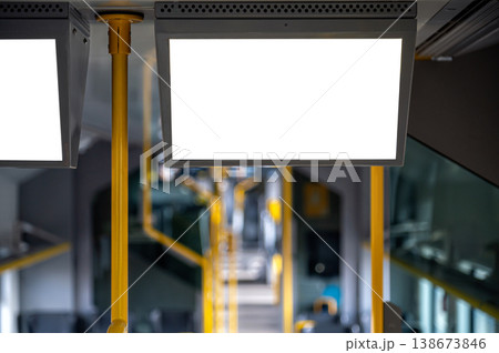 Blank display is in a public transport vehicle with empty seats and yellow poles visible Blank display is in a public transport vehicle with empty seats and yellow poles visible 138673846