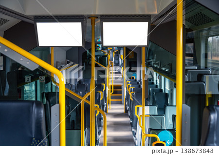 Empty bus interior shows seats and blank display panels. Space for advertisement or design. 138673848