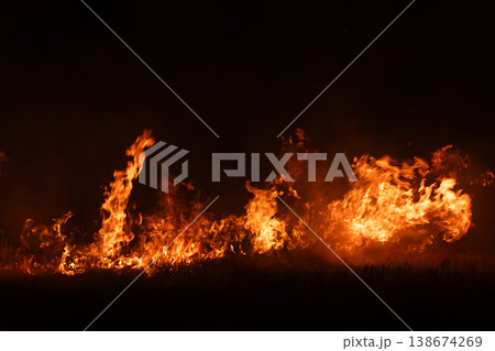 Burning fire flames isolated on dark background with smoke, dramatic wildfire effect, high contrast fire texture for overlay and design use. Burning fire flames isolated on dark background with smoke, dramatic wildfire effect, high contrast fire texture for overlay and design use. 138674269