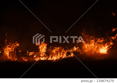 Burning fire flames isolated on dark background with smoke, dramatic wildfire effect, high contrast fire texture for overlay and design use. Burning fire flames isolated on dark background with smoke, dramatic wildfire effect, high contrast fire texture for overlay and design use. 138674270