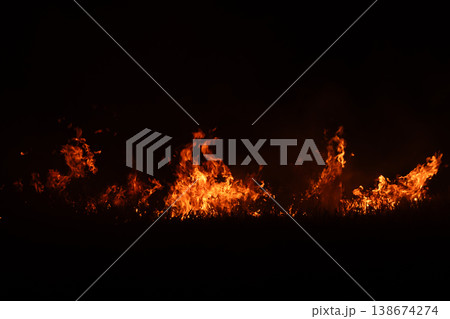 Burning fire flames isolated on dark background with smoke, dramatic wildfire effect, high contrast fire texture for overlay and design use. Burning fire flames isolated on dark background with smoke, dramatic wildfire effect, high contrast fire texture for overlay and design use. 138674274