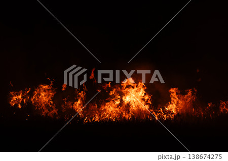 Burning fire flames isolated on dark background with smoke, dramatic wildfire effect, high contrast fire texture for overlay and design use. Burning fire flames isolated on dark background with smoke, dramatic wildfire effect, high contrast fire texture for overlay and design use. 138674275