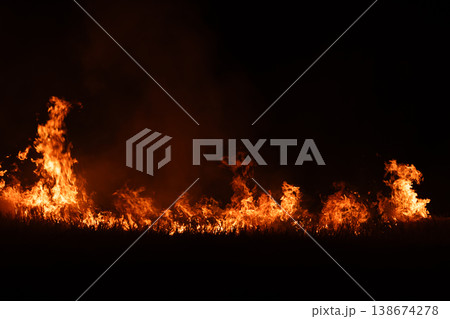 Burning fire flames isolated on dark background with smoke, dramatic wildfire effect, high contrast fire texture for overlay and design use. 138674278