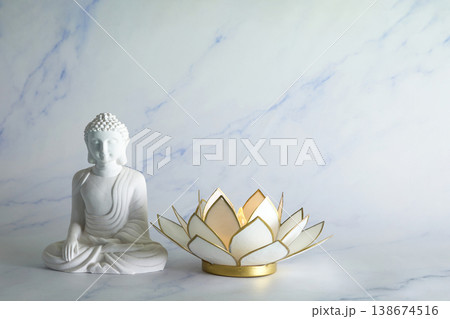 Vesak Buddha birthday. White buddha statue and lotus candle holder 138674516