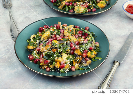 Seafood salad with shrimp, mussels, squid and pomegranate 138674702