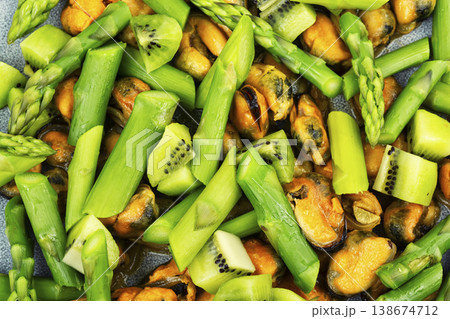 healthy seafood salad with mussels asparagus and kiwi 138674712