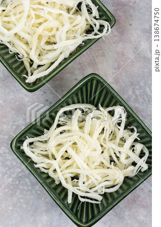 Dried squid in bowl, minimal food composition. 138674750