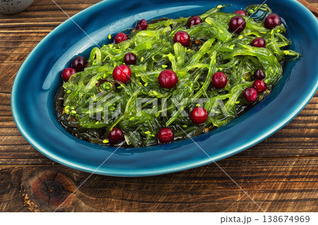 Green Seaweed Salad with Cranberries, Asian Style Dish 138674969