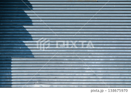 Industrial Metal Roller Shutter Door Texture Blue Corrugated Steel Gate Background with Shadow Industrial Metal Roller Shutter Door Texture Blue Corrugated Steel Gate Background with Shadow 138675970