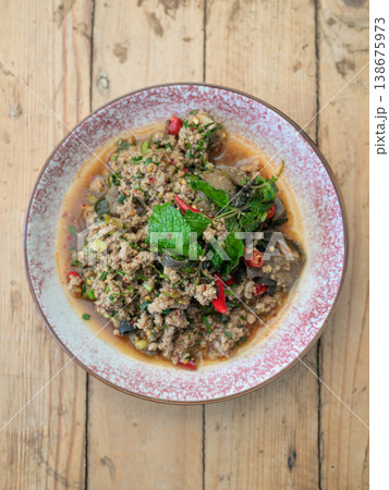 Authentic Thai Beef Larb Salad Laab Neua Spicy Ground Meat Dish on Wooden Table with Copy Space Authentic Thai Beef Larb Salad Laab Neua Spicy Ground Meat Dish on Wooden Table with Copy Space 138675973