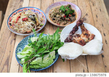 Authentic Thai Isan Food Set Som Tum Papaya Salad, Beef Larb, Grilled Chicken and Sticky Rice Authentic Thai Isan Food Set Som Tum Papaya Salad, Beef Larb, Grilled Chicken and Sticky Rice 138675978
