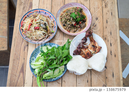 Authentic Thai Isan Food Set Som Tum Papaya Salad, Beef Larb, Grilled Chicken and Sticky Rice Authentic Thai Isan Food Set Som Tum Papaya Salad, Beef Larb, Grilled Chicken and Sticky Rice 138675979