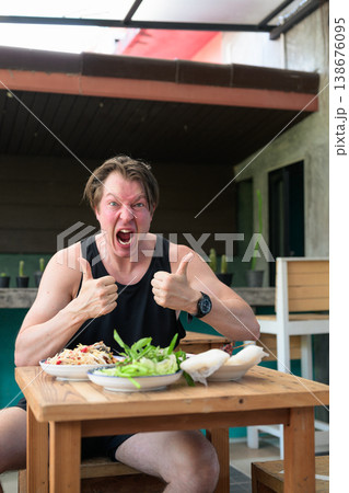 Shocked Man Giving Thumbs Up with Spicy Thai Food Som Tum Papaya Salad Expression Vertical 138676095