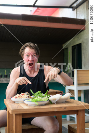 Shocked Man Pointing at Spicy Thai Food Som Tum Papaya Salad Expression Vertical Copy Space Shocked Man Pointing at Spicy Thai Food Som Tum Papaya Salad Expression Vertical Copy Space 138676096