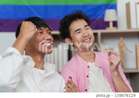 LGBTQIA couple enjoying creative makeup session 138676129
