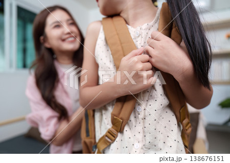 Mother assisting daughter with back-to-school preparation Mother assisting daughter with back-to-school preparation 138676151