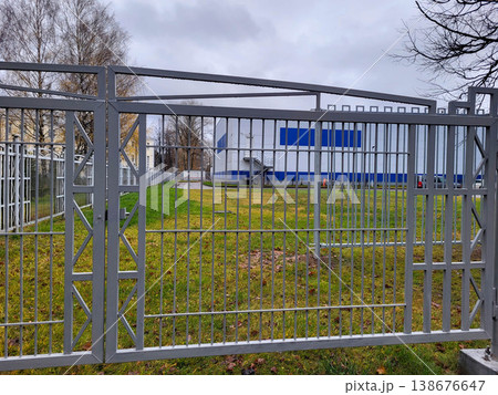 On an autumn day, a gray fence with raindrops. On an autumn day, a gray fence with raindrops. 138676647