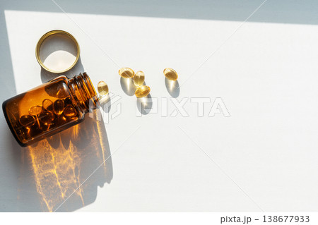 Glass dark bottle spilling vitamin pills, symbolizing daily health and wellness supplements, enhancing personal healthcare. Pills spilling from bottle for health treatments Glass dark bottle spilling vitamin pills, symbolizing daily health and wellness supplements, enhancing personal healthcare. Pills spilling from bottle for health treatments 138677933