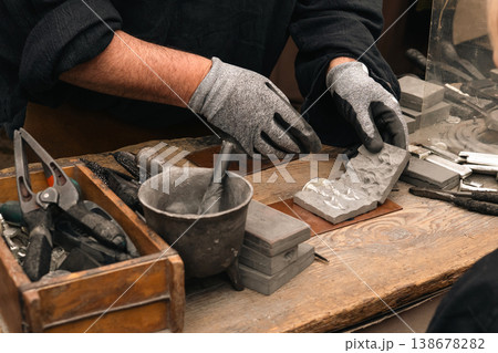 Craftsman working with molds at festival market stall in Berlin Craftsman working with molds at festival market stall in Berlin 138678282