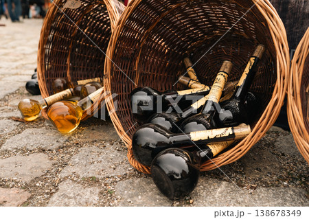 Dark glass bottles in wicker baskets at festival market in Berlin Dark glass bottles in wicker baskets at festival market in Berlin 138678349