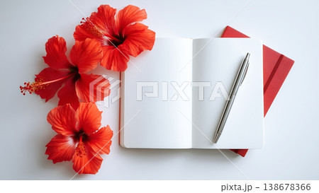 白背景のデスクに開いたノートとペン　ハイビスカス 138678366