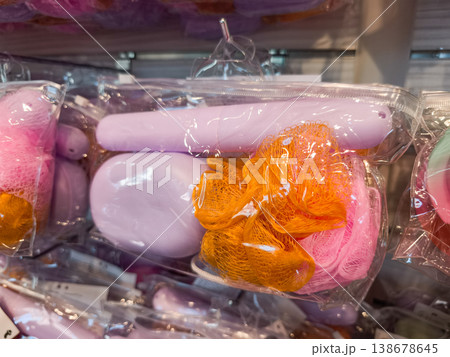 Colorful bath sponges and accessories hanging in plastic packaging, promoting hygiene and body care Colorful bath sponges and accessories hanging in plastic packaging, promoting hygiene and body care 138678645