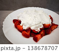 Fresh strawberries topped with creamy whipped cream dessert on a white plate delicious treat concept. copy space 138678707