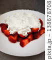 Fresh strawberries topped with whipped cream dessert on a white plate delicious treat concept. copy space 138678708