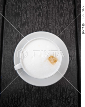 Creamy coffee cup Cappuccino with frothy milk on dark wooden table perfect for coffee lovers concept. copy space Creamy coffee cup Cappuccino with frothy milk on dark wooden table perfect for coffee lovers concept. copy space 138678720